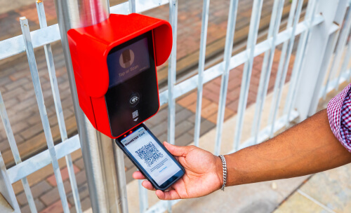 Phone, displaying the QR code associated with a RideMETRO Fare Card, scanned under a fare validator